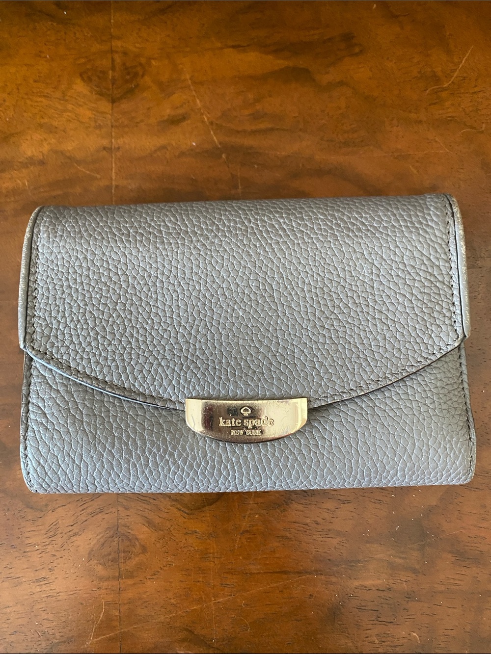 kate spade gray pebbled leather flap wallet with gold plaque